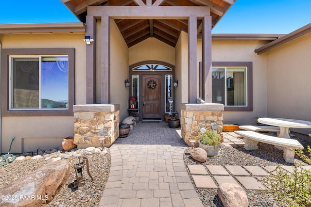 entrance to property with stucco siding