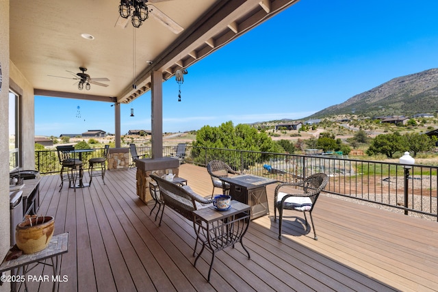 deck with ceiling fan and a mountain view