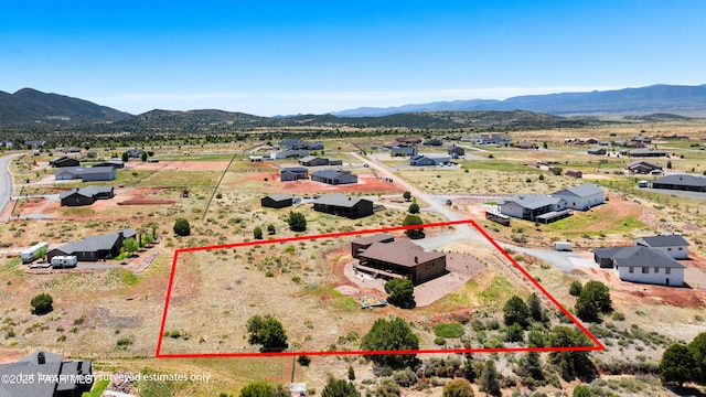 birds eye view of property with a mountain view