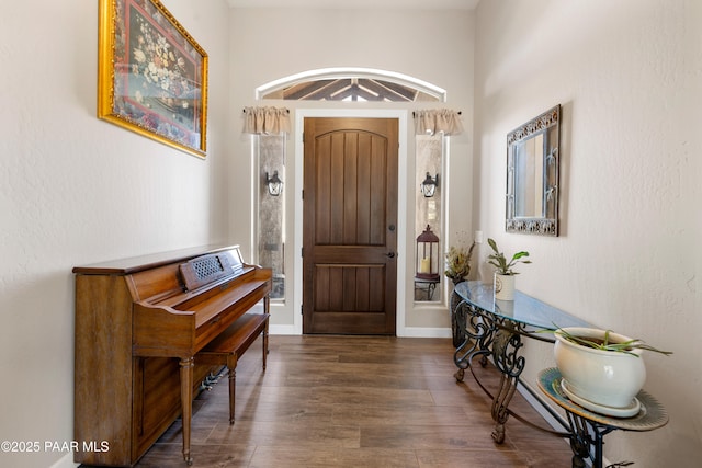 entryway featuring wood finished floors and baseboards