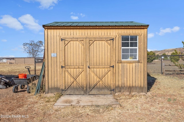 view of shed with fence