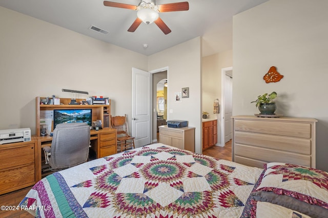 bedroom with arched walkways, visible vents, connected bathroom, and ceiling fan
