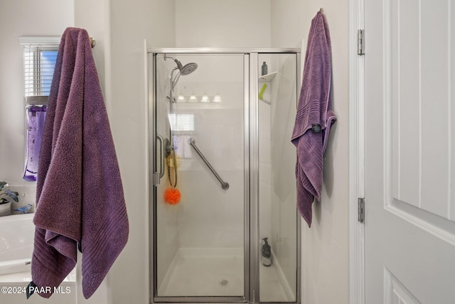 full bath with a shower stall