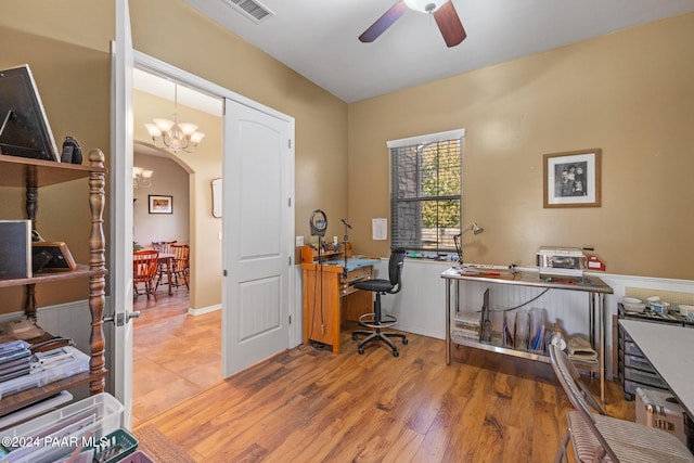 office featuring arched walkways, visible vents, ceiling fan with notable chandelier, and wood finished floors