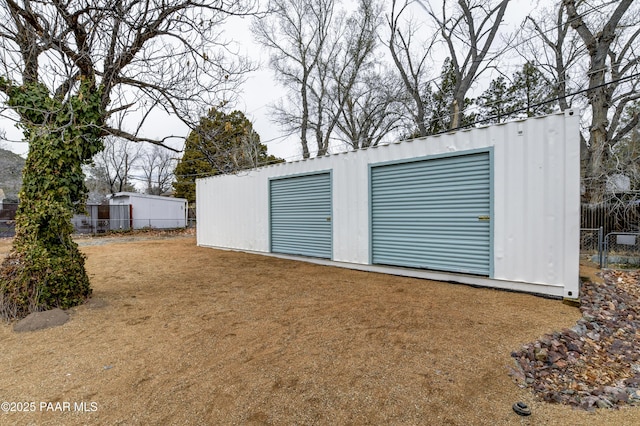 garage with fence