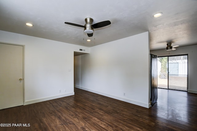 spare room with baseboards, wood finished floors, visible vents, and recessed lighting