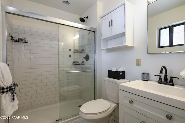 full bathroom featuring toilet, a tile shower, and vanity