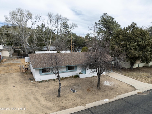 view of front of house featuring driveway and a shingled roof