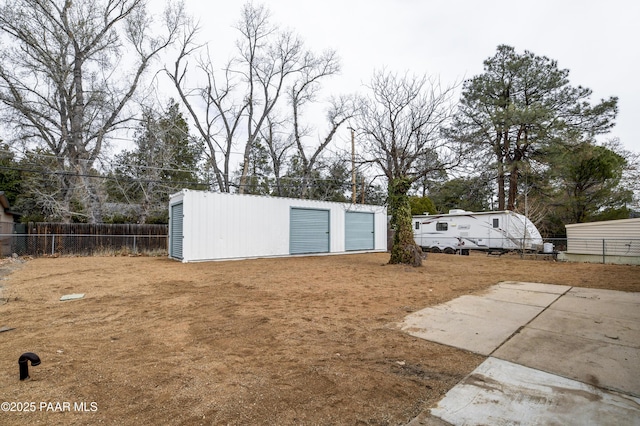 view of yard featuring an outdoor structure and fence