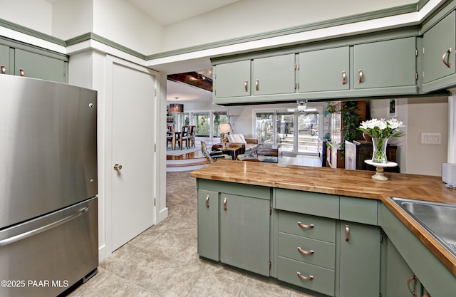 2009 Rocky Dells Dr, Prescott, AZ 86303 - kitchen with freestanding refrigerator, green cabinetry, butcher block countertops, and light tile patterned flooring