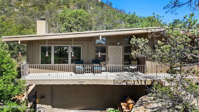 2009 Rocky Dells Dr, Prescott, AZ 86303 - back of property with an attached garage and a chimney