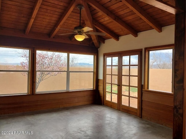 unfurnished sunroom with vaulted ceiling with beams, a wealth of natural light, ceiling fan, and wooden ceiling