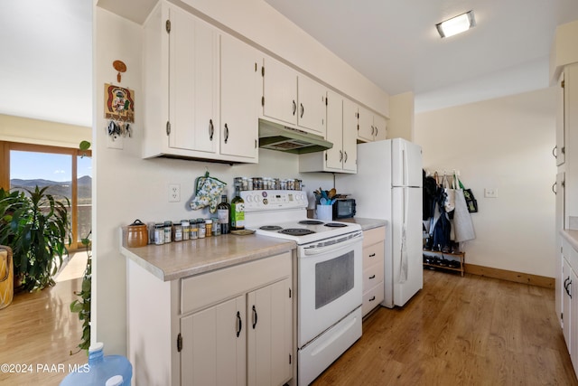 kitchen featuring white cabinets, light hardwood / wood-style floors, and white appliances