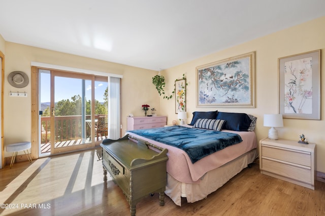 bedroom with access to exterior and light wood-type flooring