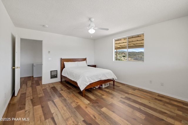 8910 S Steven Trl, Kirkland, AZ 86332 - bedroom featuring wood-type flooring, ceiling fan, a textured ceiling, and baseboards