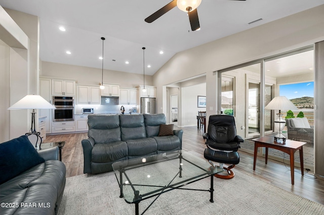 12612 E E Side Saddle Ln, Prescott Valley, AZ 86315 - living room featuring light wood-style flooring, a ceiling fan, recessed lighting, and high vaulted ceiling