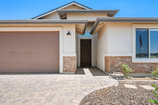 12612 E E Side Saddle Ln, Prescott Valley, AZ 86315 - property entrance with stucco siding, a garage, and brick siding