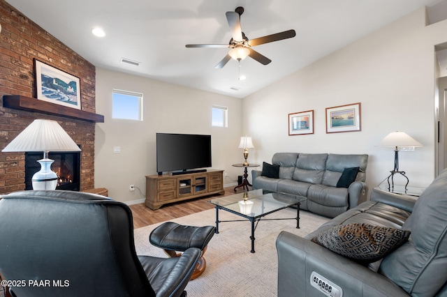 12612 E E Side Saddle Ln, Prescott Valley, AZ 86315 - living room featuring wood finished floors, a ceiling fan, lofted ceiling, and a brick fireplace