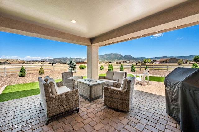 12612 E E Side Saddle Ln, Prescott Valley, AZ 86315 - fenced backyard with a mountain view, a patio area, an outdoor living space, and area for grilling