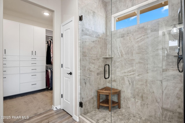 12612 E E Side Saddle Ln, Prescott Valley, AZ 86315 - bathroom featuring a shower stall, a spacious closet, and wood finished floors