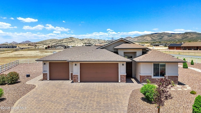 12612 E E Side Saddle Ln, Prescott Valley, AZ 86315 - prairie-style home with a garage, stucco siding, a mountain view, decorative driveway, and brick siding