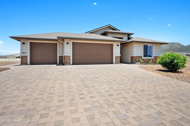 12612 E E Side Saddle Ln, Prescott Valley, AZ 86315 - prairie-style house with stucco siding, an attached garage, decorative driveway, and stone siding
