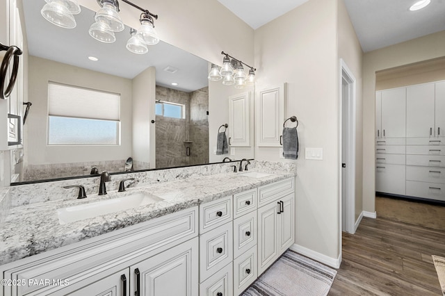 12612 E E Side Saddle Ln, Prescott Valley, AZ 86315 - bathroom with a stall shower, double vanity, and wood finished floors