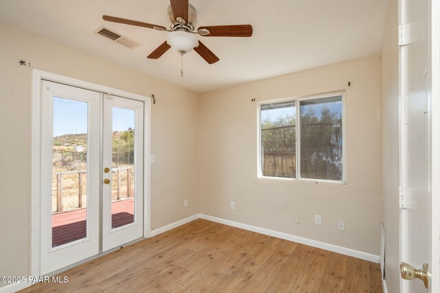 7555 W Wexford Dr, Wilhoit, AZ 86332 - empty room featuring french doors, light wood-style flooring, and ceiling fan