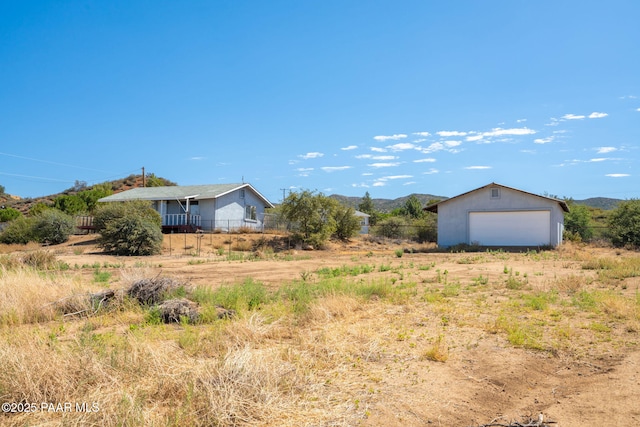 7555 W Wexford Dr, Wilhoit, AZ 86332 - view of yard featuring an outdoor structure, a detached garage, a mountain view, and a view of countryside