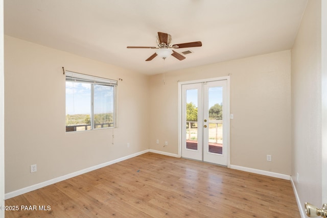 7555 W Wexford Dr, Wilhoit, AZ 86332 - empty room with french doors, healthy amount of natural light, ceiling fan, and light wood-type flooring