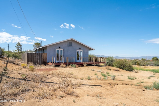 7555 W Wexford Dr, Wilhoit, AZ 86332 - rear view of property with french doors, stucco siding, and a deck with mountain view