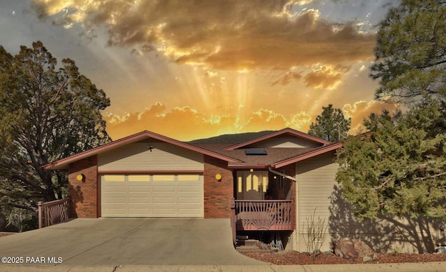 1255 Solar Heights Dr, Prescott, AZ 86303 - view of front of home with concrete driveway, a garage, and brick siding