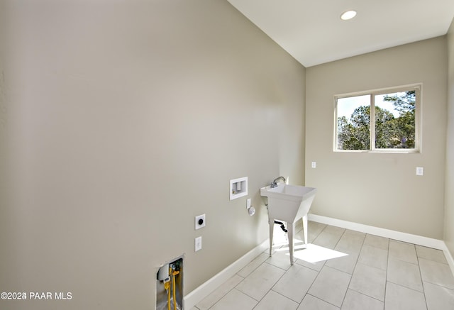 clothes washing area featuring light tile patterned flooring, sink, washer hookup, hookup for an electric dryer, and hookup for a gas dryer