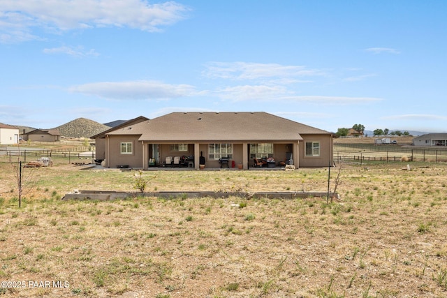 rear view of house with a patio area and a fenced backyard