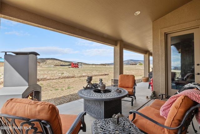 view of patio featuring a mountain view and an outdoor living space