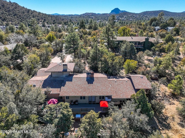 birds eye view of property with a forest view and a mountain view