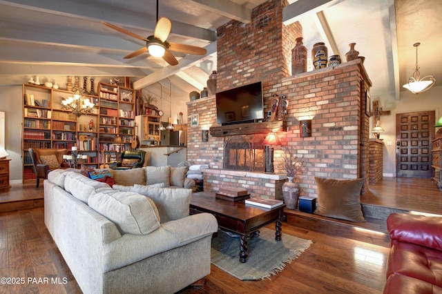 living area with hardwood / wood-style flooring, a fireplace, a ceiling fan, and beamed ceiling