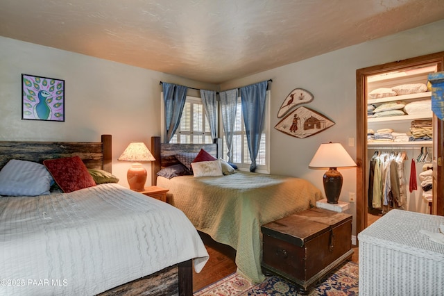 bedroom with a closet and wood finished floors