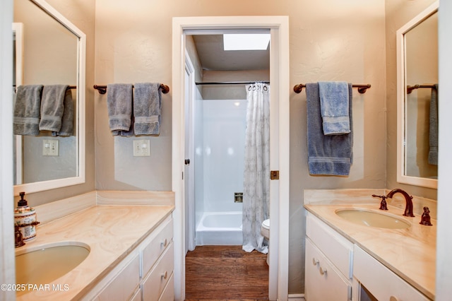 full bath with toilet, shower / bath combo, wood finished floors, and vanity