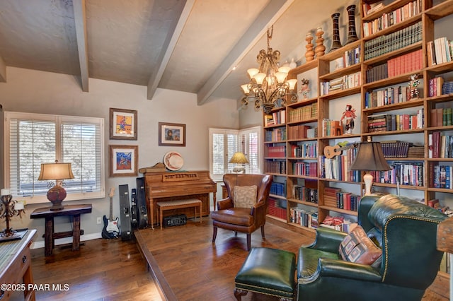sitting room with baseboards, wood finished floors, beam ceiling, and an inviting chandelier