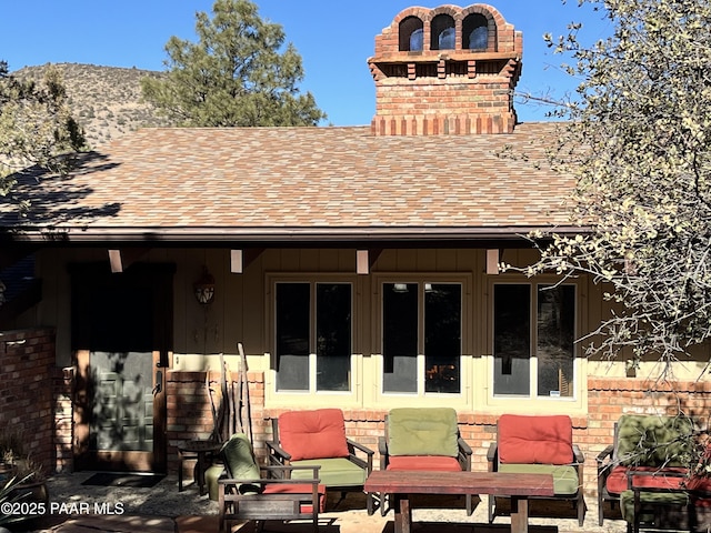 back of property featuring a patio area and an outdoor living space