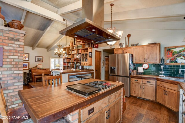 kitchen featuring a chandelier, lofted ceiling with beams, butcher block counters, appliances with stainless steel finishes, and island exhaust hood