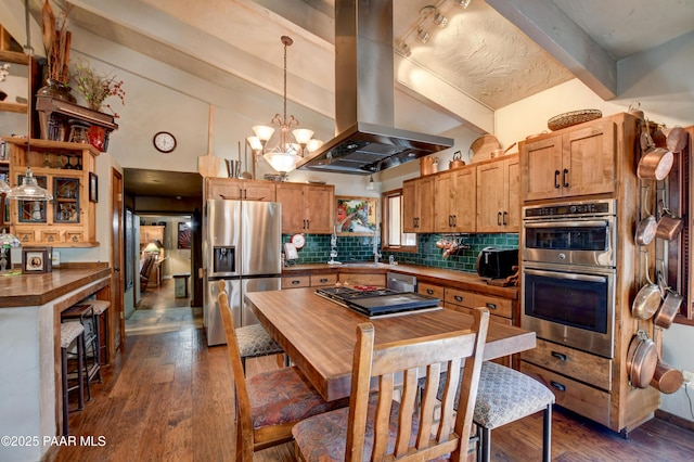 kitchen with island range hood, butcher block countertops, appliances with stainless steel finishes, backsplash, and dark wood finished floors