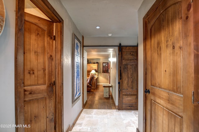 hall featuring a barn door