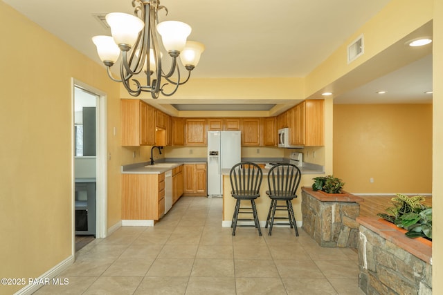 3045 Hozoni Rd, Prescott, AZ 86305 - kitchen with white appliances, a sink, a chandelier, a peninsula, and recessed lighting