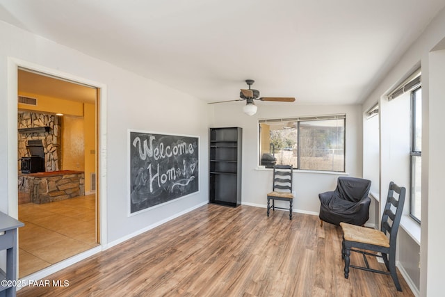 3045 Hozoni Rd, Prescott, AZ 86305 - sitting room with wood finished floors, a ceiling fan, a fireplace, and baseboards