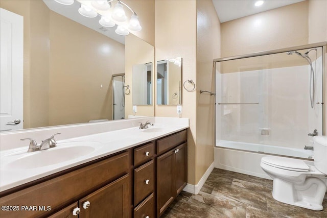 bathroom featuring double vanity, toilet, bathtub / shower combination, and a sink