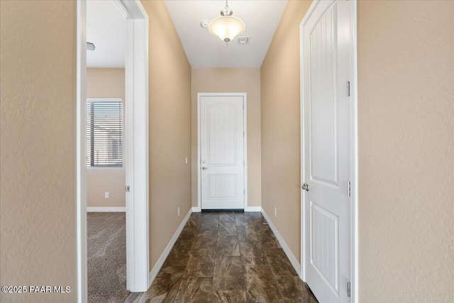 doorway featuring baseboards