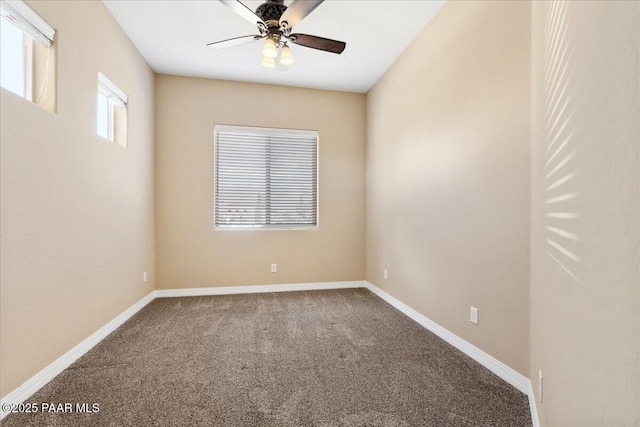 empty room with carpet flooring, baseboards, and ceiling fan