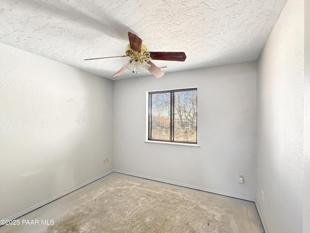 unfurnished room with baseboards, a textured ceiling, unfinished concrete flooring, and ceiling fan